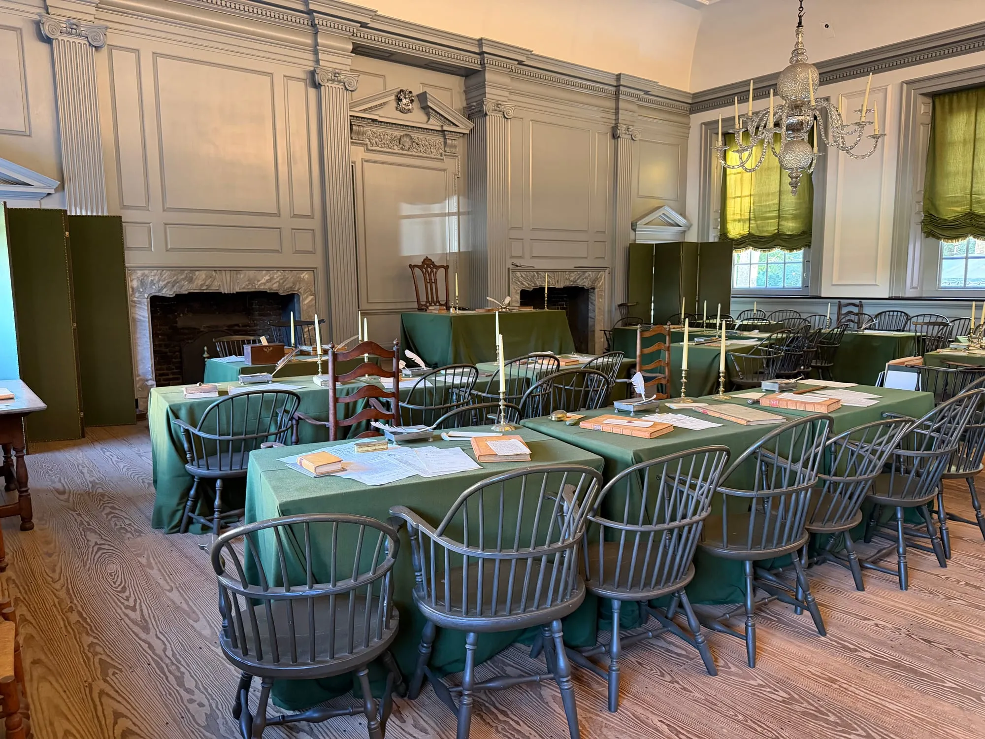 The Assembly Room inside Independence Hall, with green-covered tables and Windsor chairs