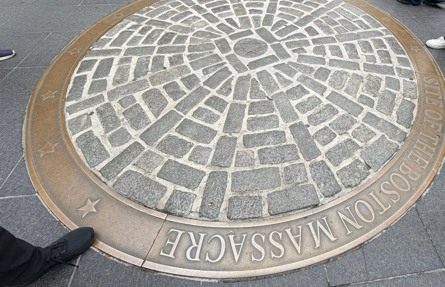 The cobblestone circle and bronze ring marking the site of the Boston Massacre