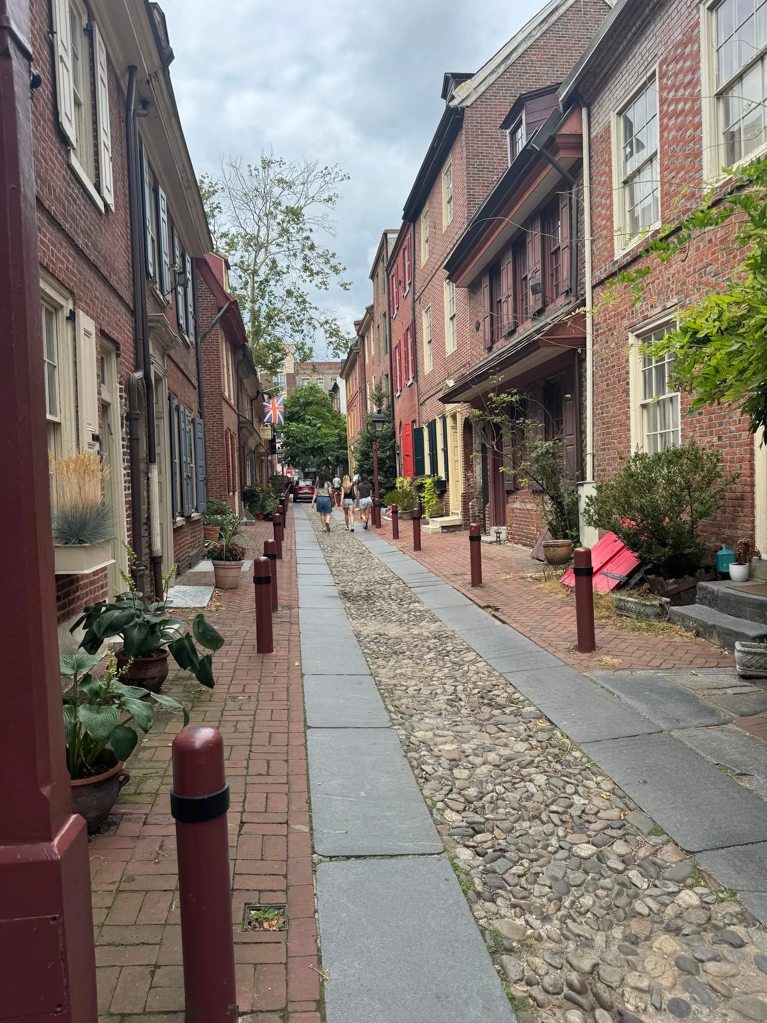 Elfreth's Alley's narrow cobblestone lane lined with colonial brick houses and flower boxes