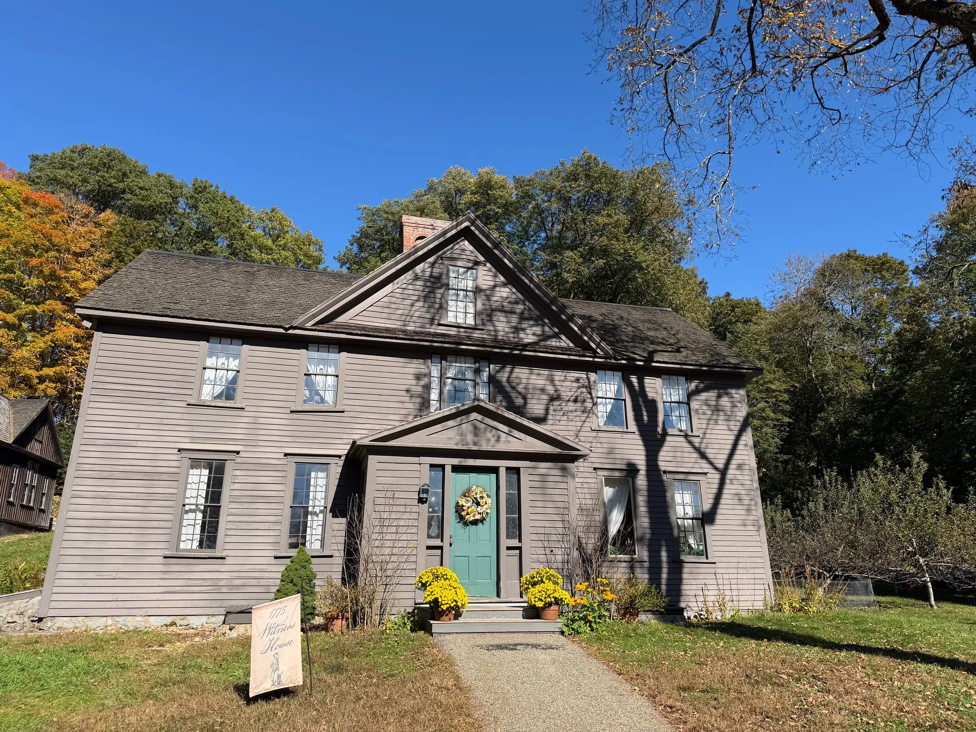 Orchard House, Louisa May Alcott's home in Concord, framed by autumn trees