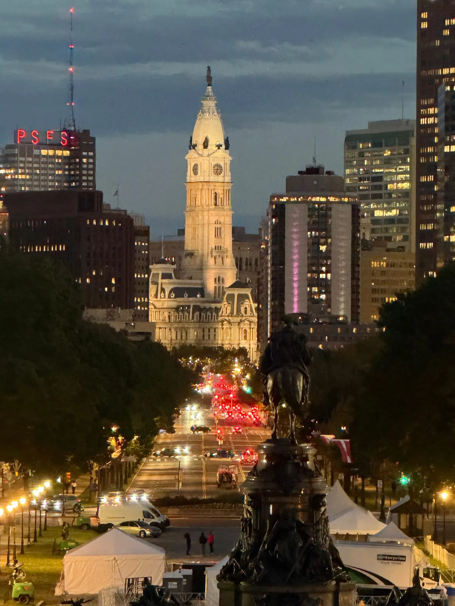 Philadelphia City Hall glowing at dusk at the end of the Benjamin Franklin Parkway