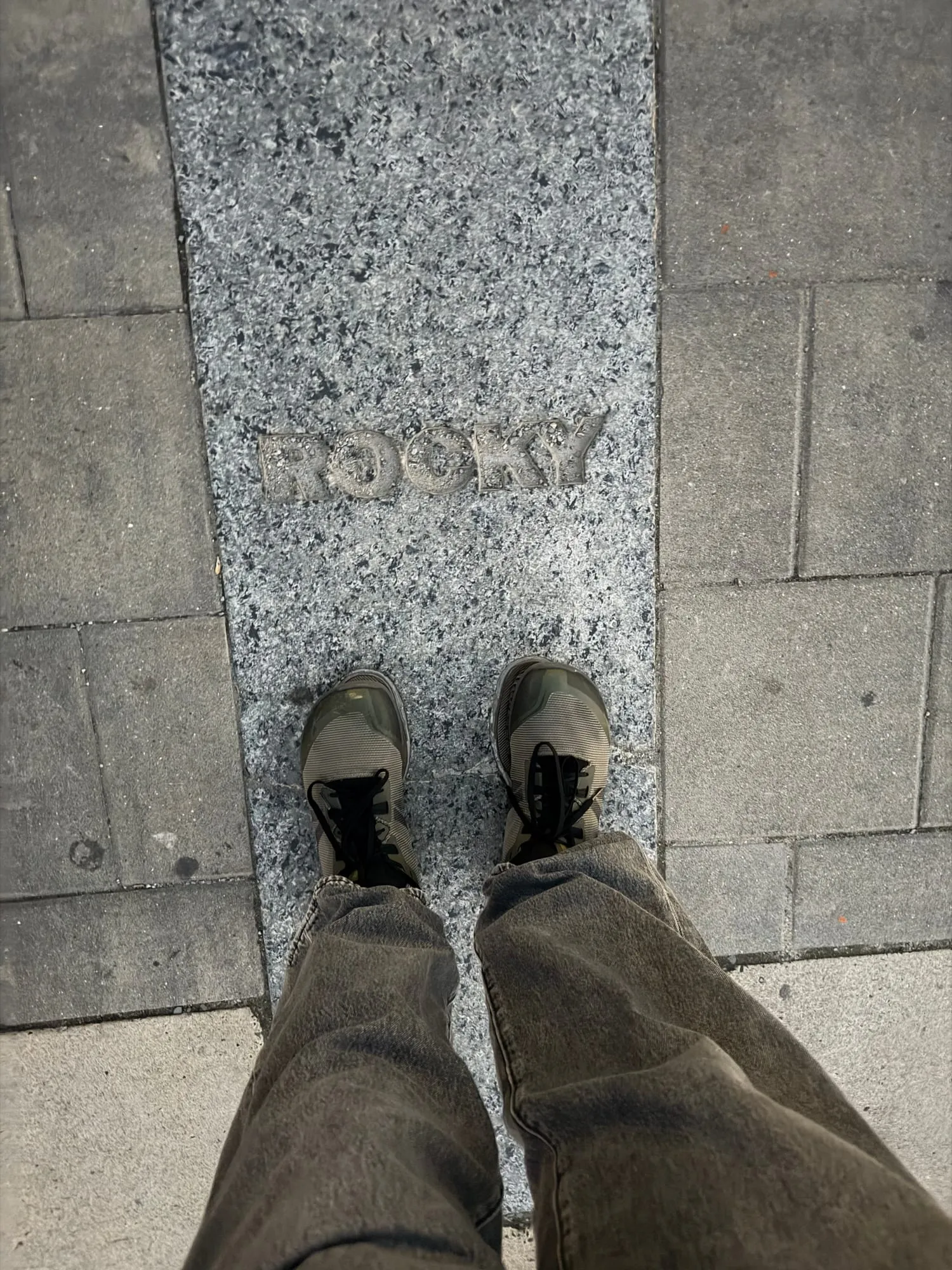 Leadership's shoes standing in the Rocky footprints at the top of the Art Museum steps