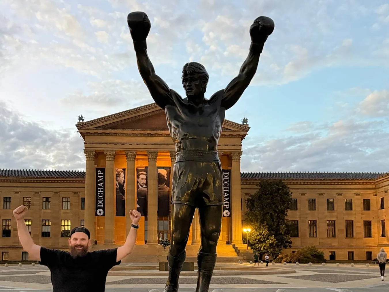 The Rocky statue with fists raised in front of the Philadelphia Museum of Art, with leadership striking the same pose