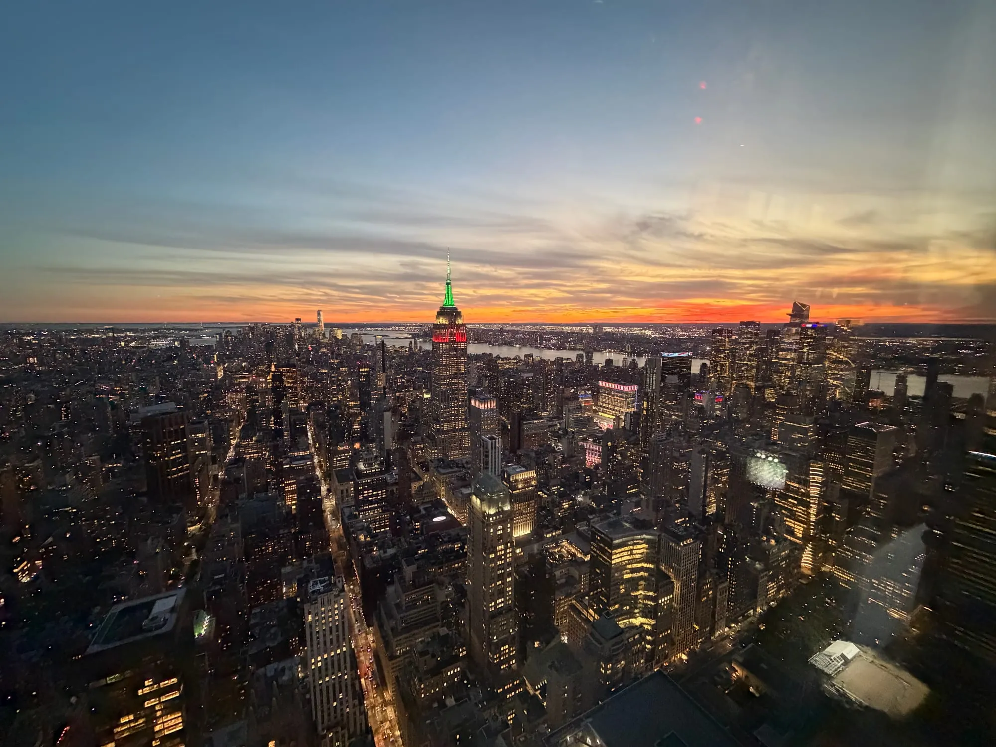 Sunset over Manhattan from high above Midtown, with the Empire State Building lit up