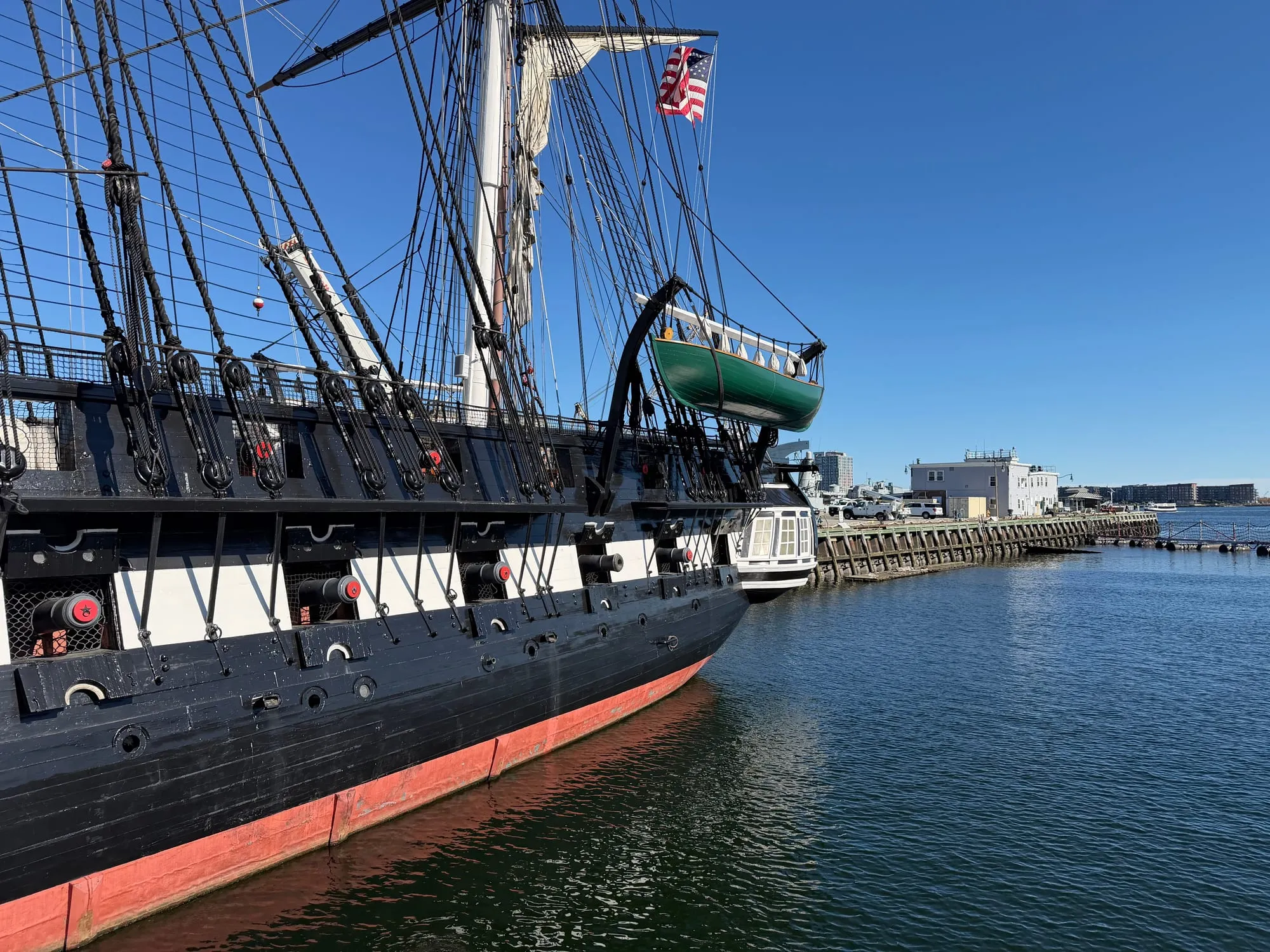 USS Constitution, a tall-masted wooden warship, docked in Charlestown